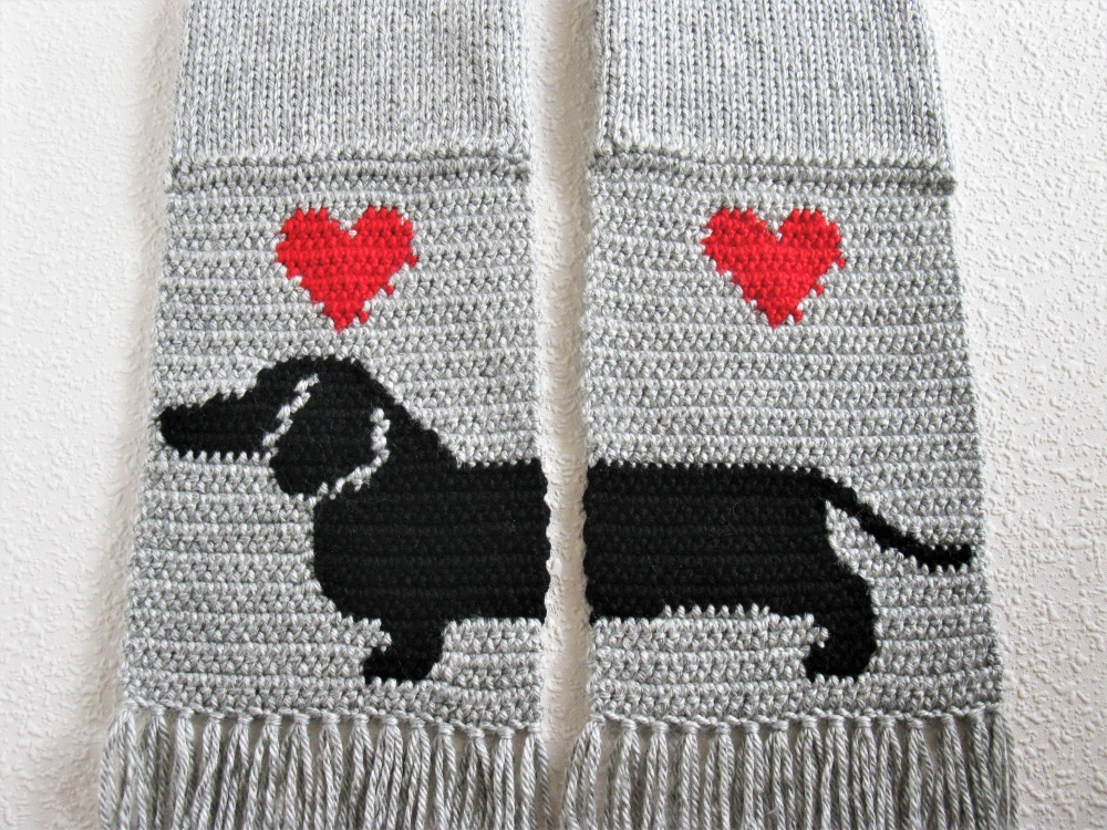 Gray knit scarf with a black Dachshund dog silhouette and red hearts