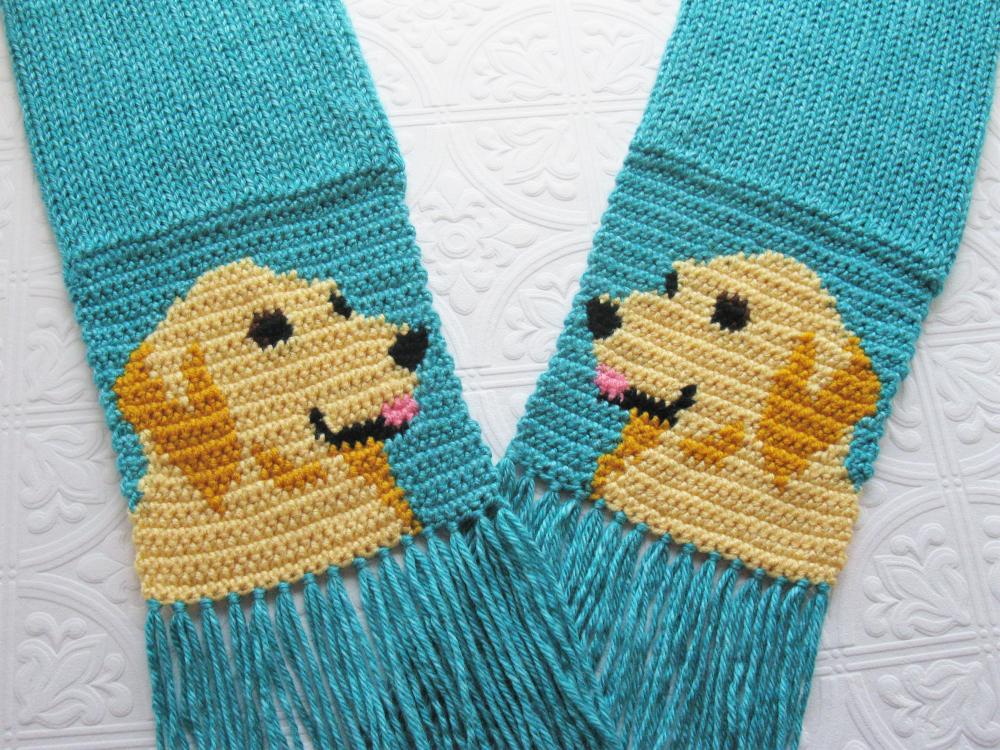 Golden Retriever Scarf. Turquoise blue knitted scarf with yellow dogs