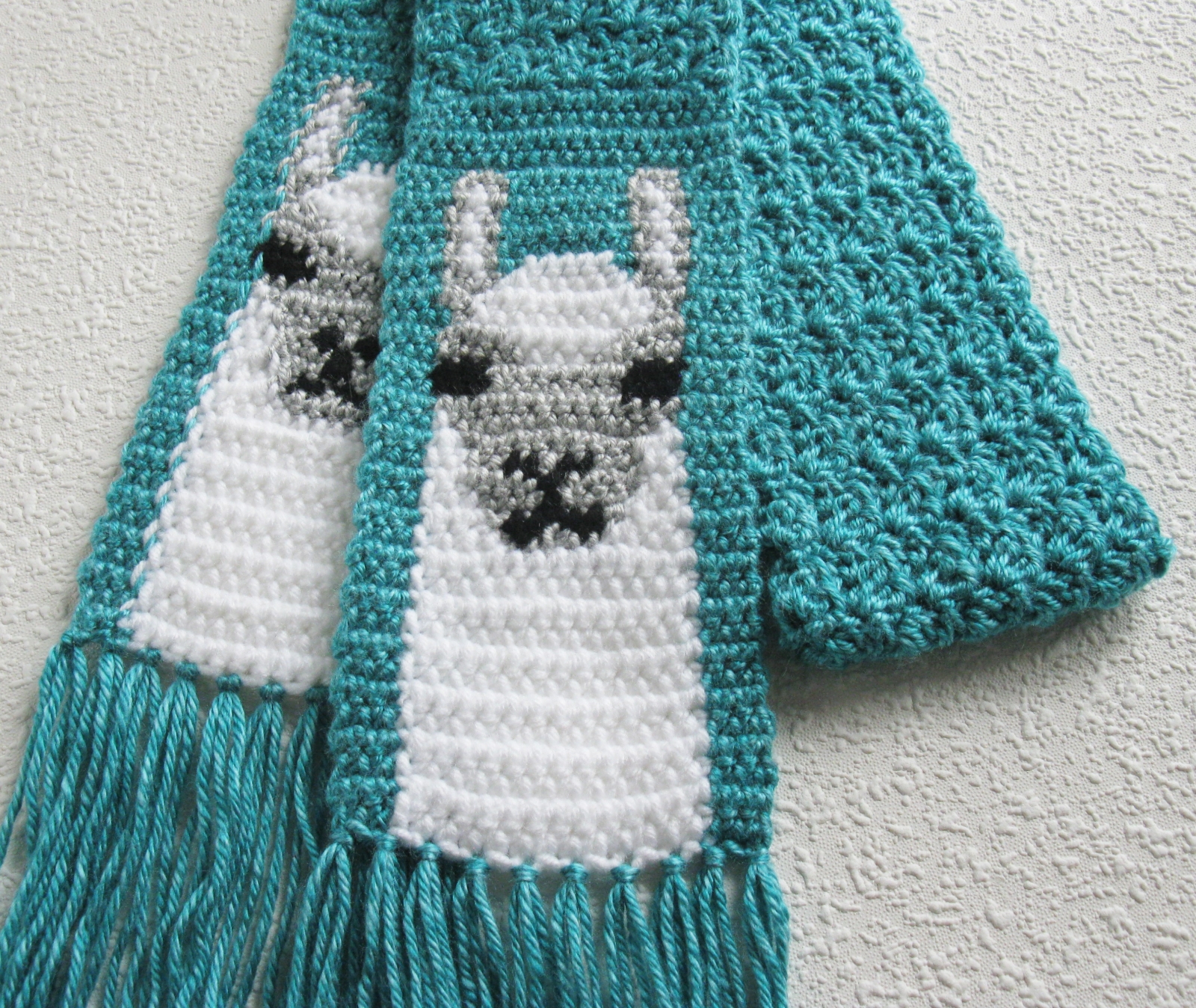 Turquoise blue scarf with crochet white Llamas or Alpacas | hooknsaw
