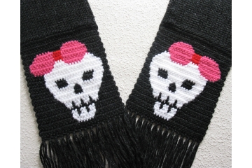 Black knit scarf with white skulls wearing pink bows